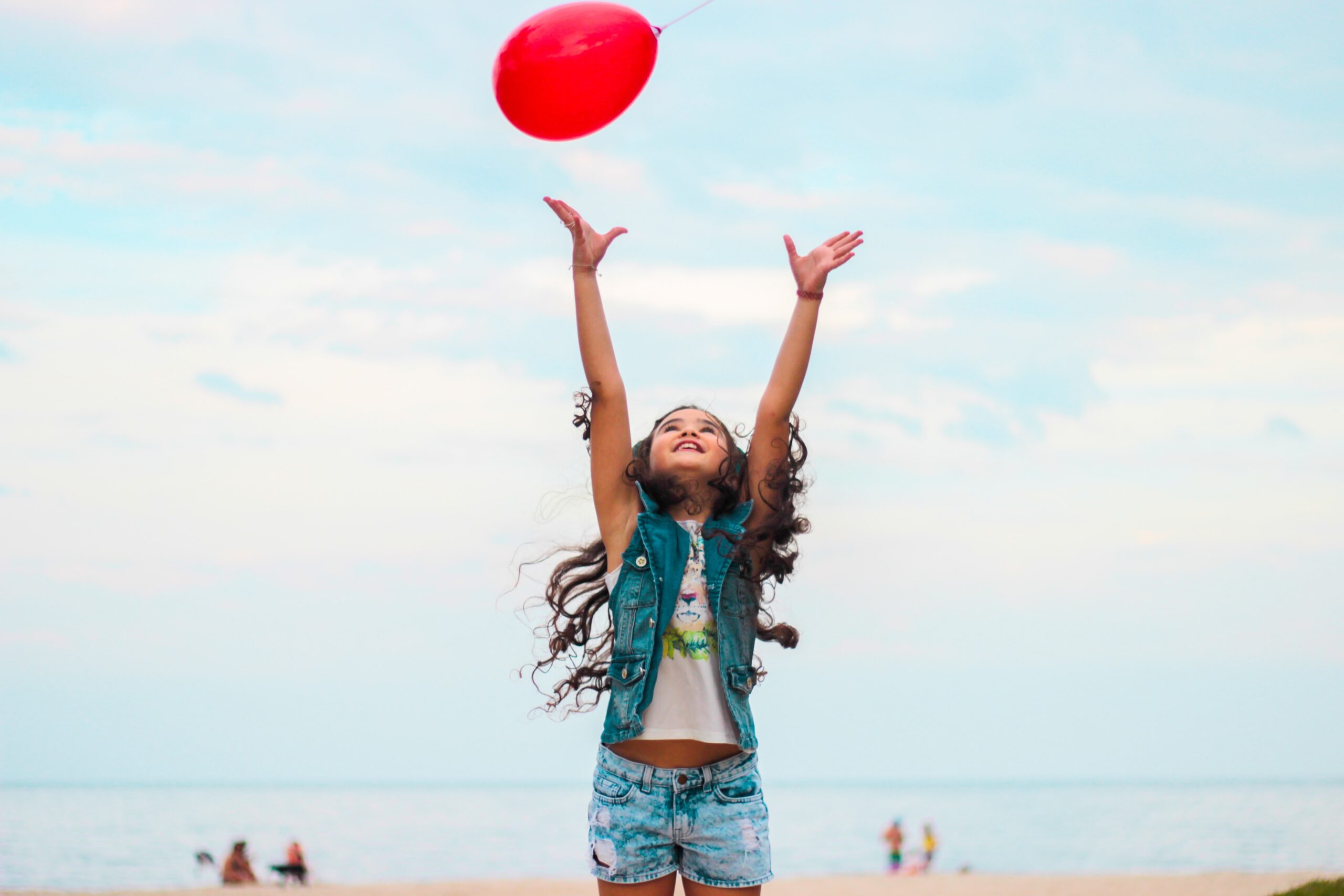 Happy student playing with a frisbee at the beach