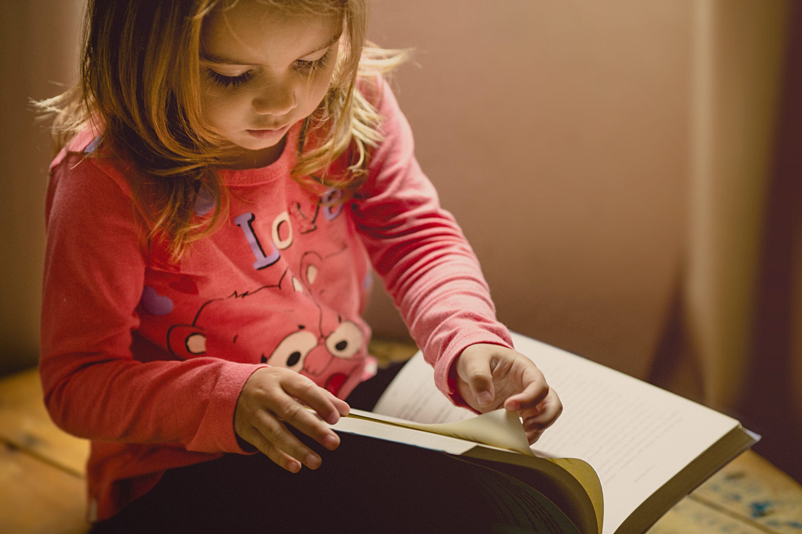 young student reading through a book