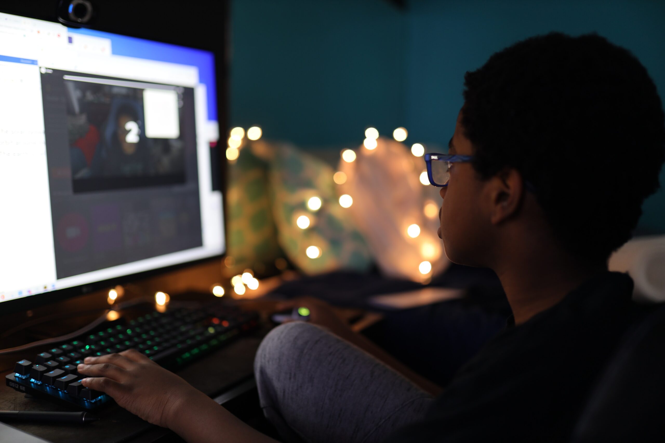 student completing homework on his computer