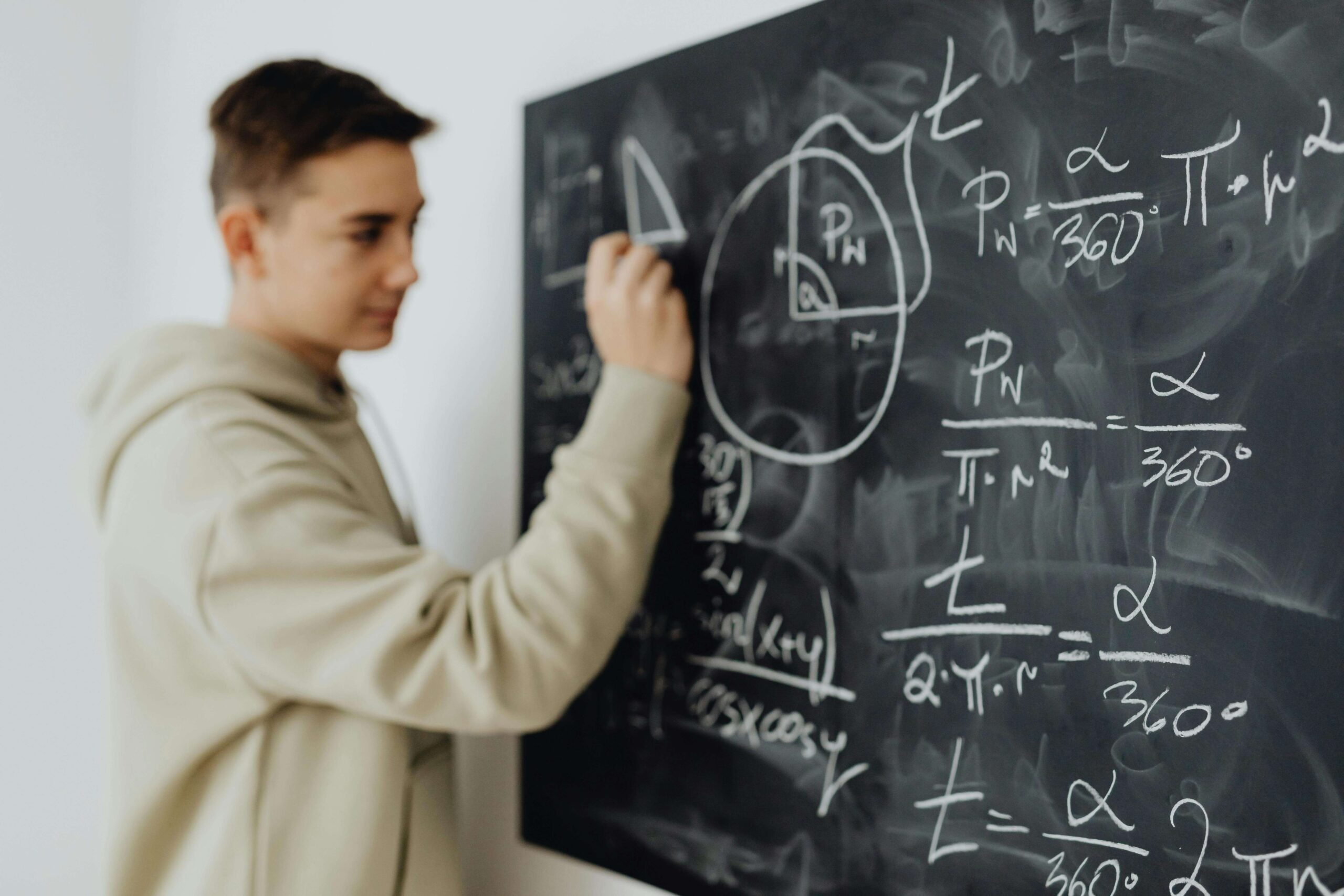 student solving a problem at the blackboard