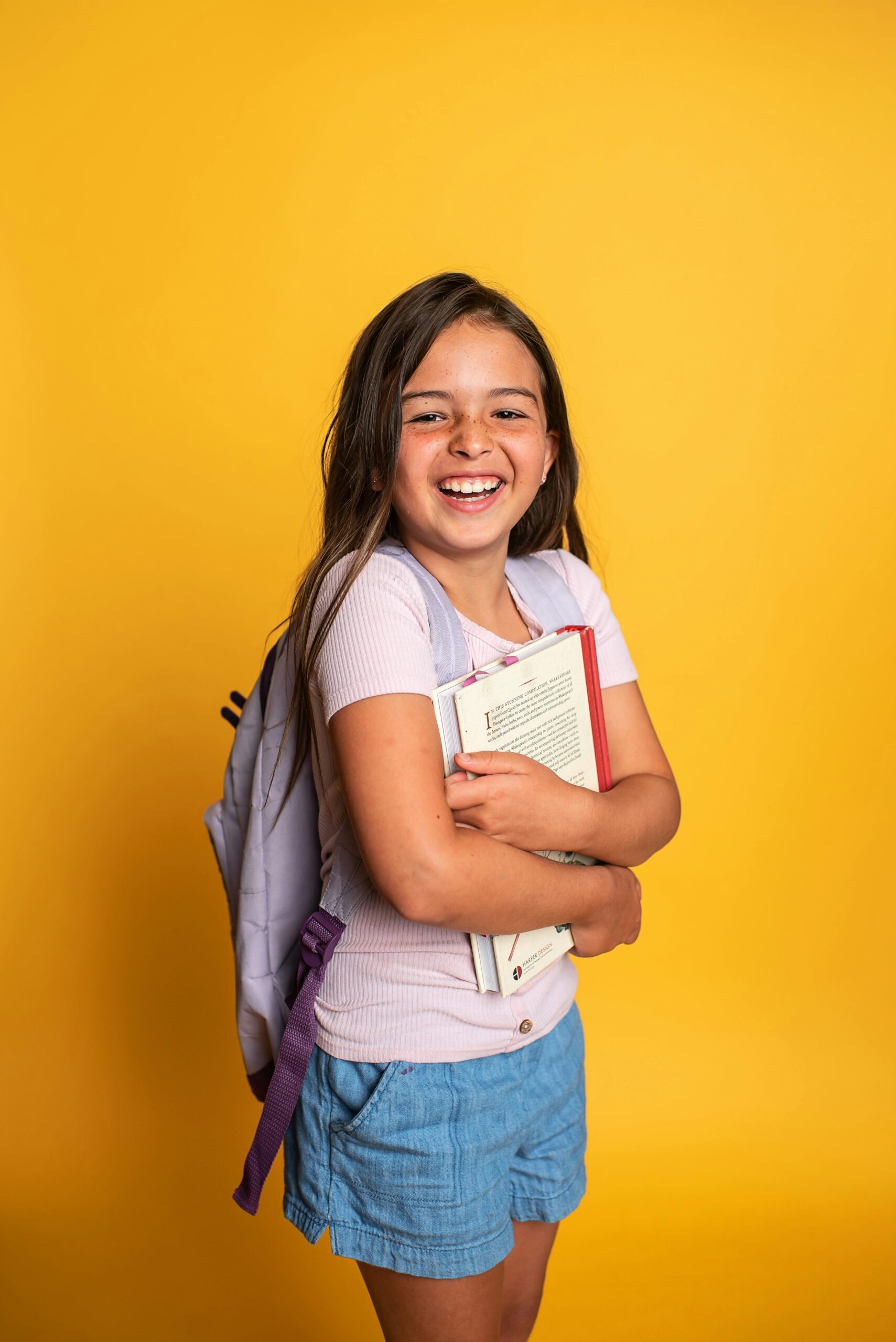 girl with adhd smiling and holding her books