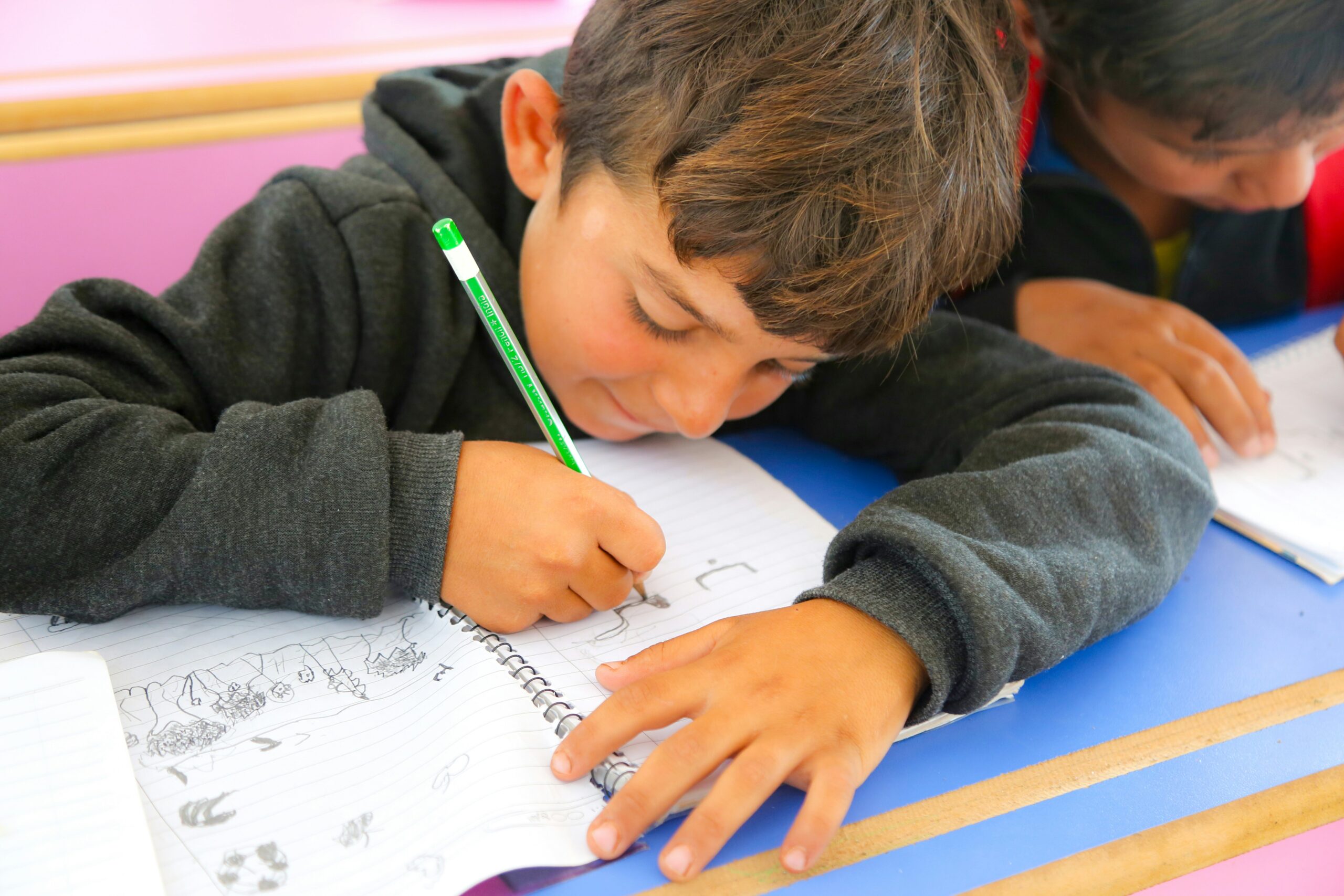 student writing in a notebook