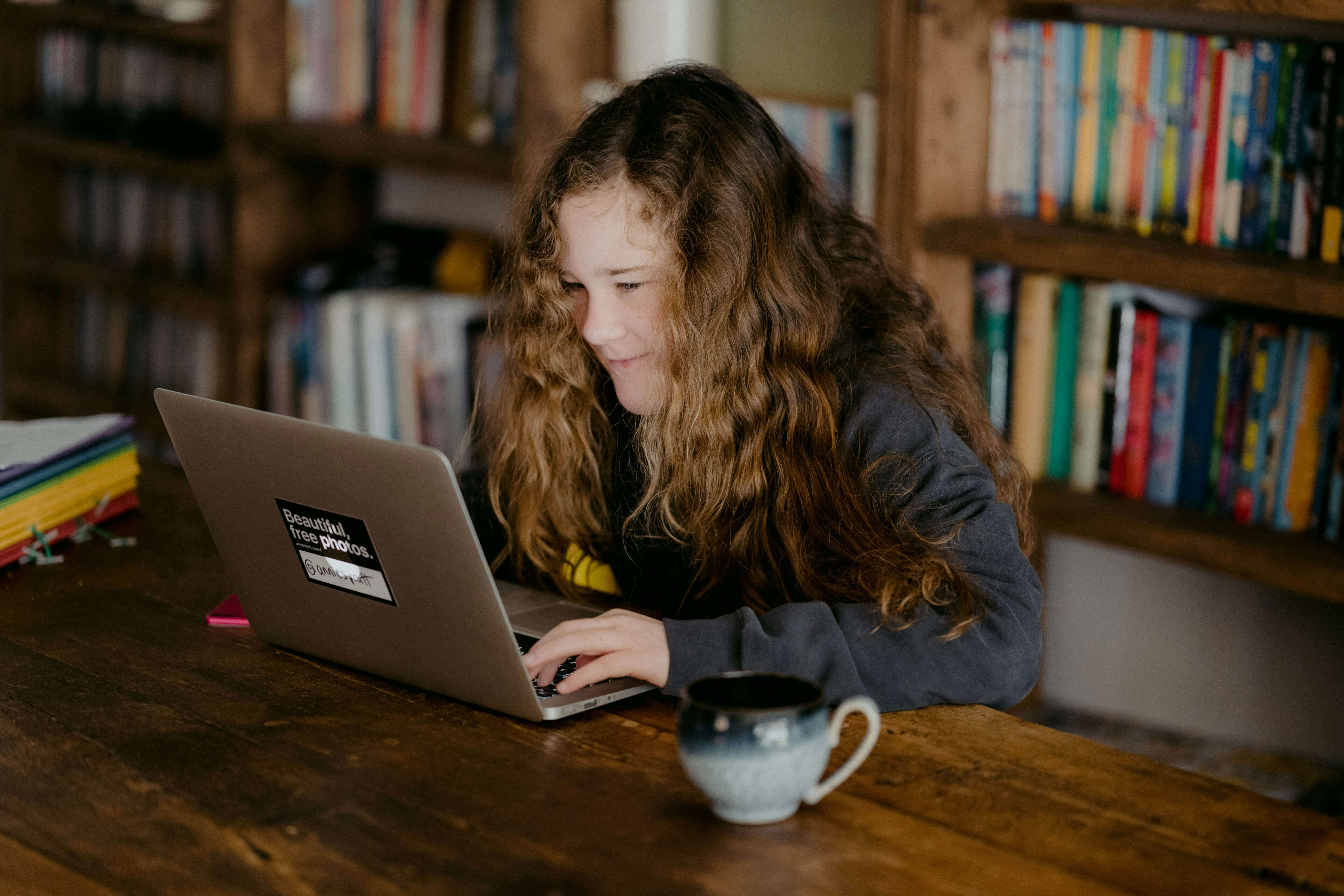 student learning on her laptop