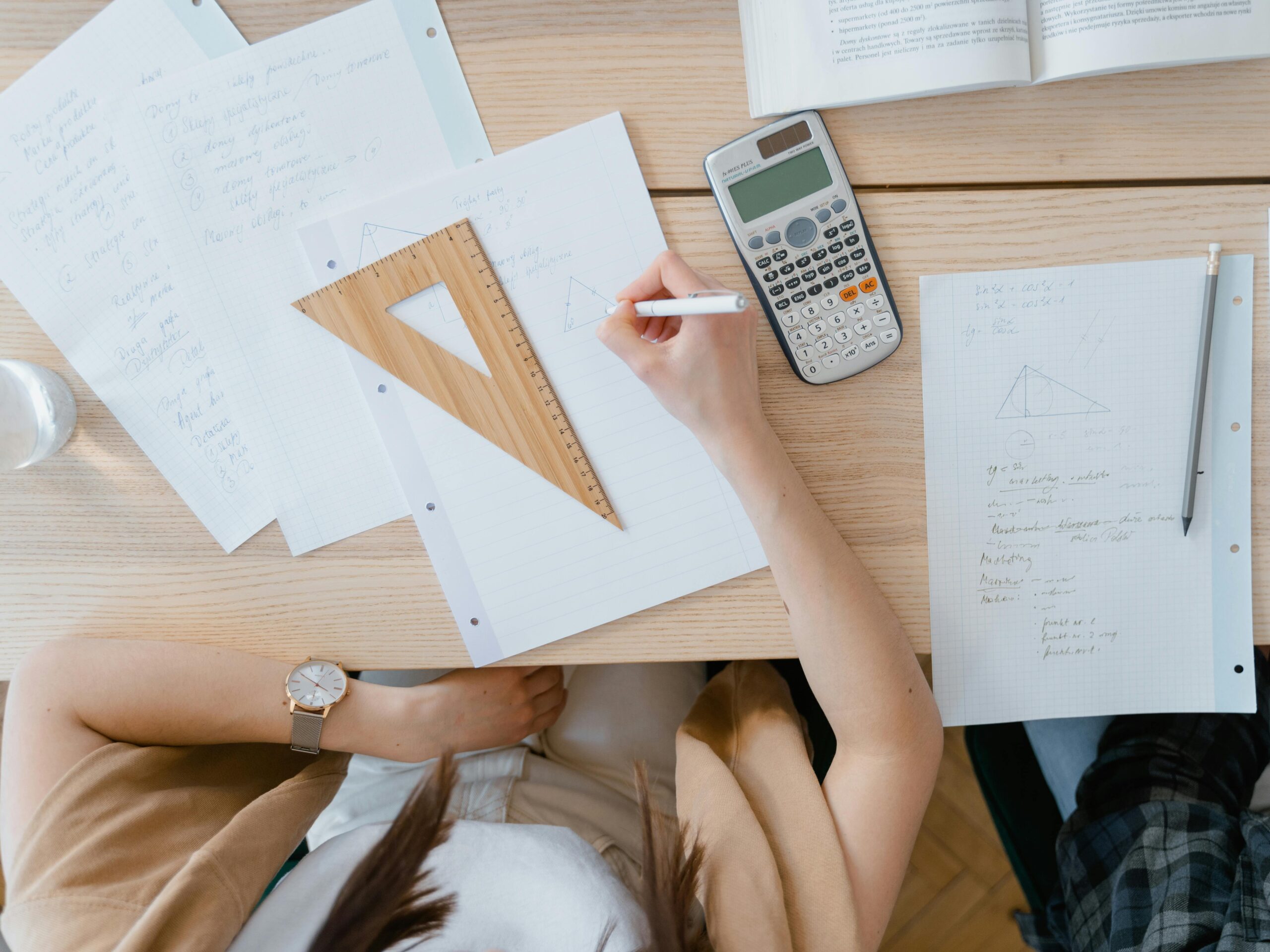 student working on math at a table