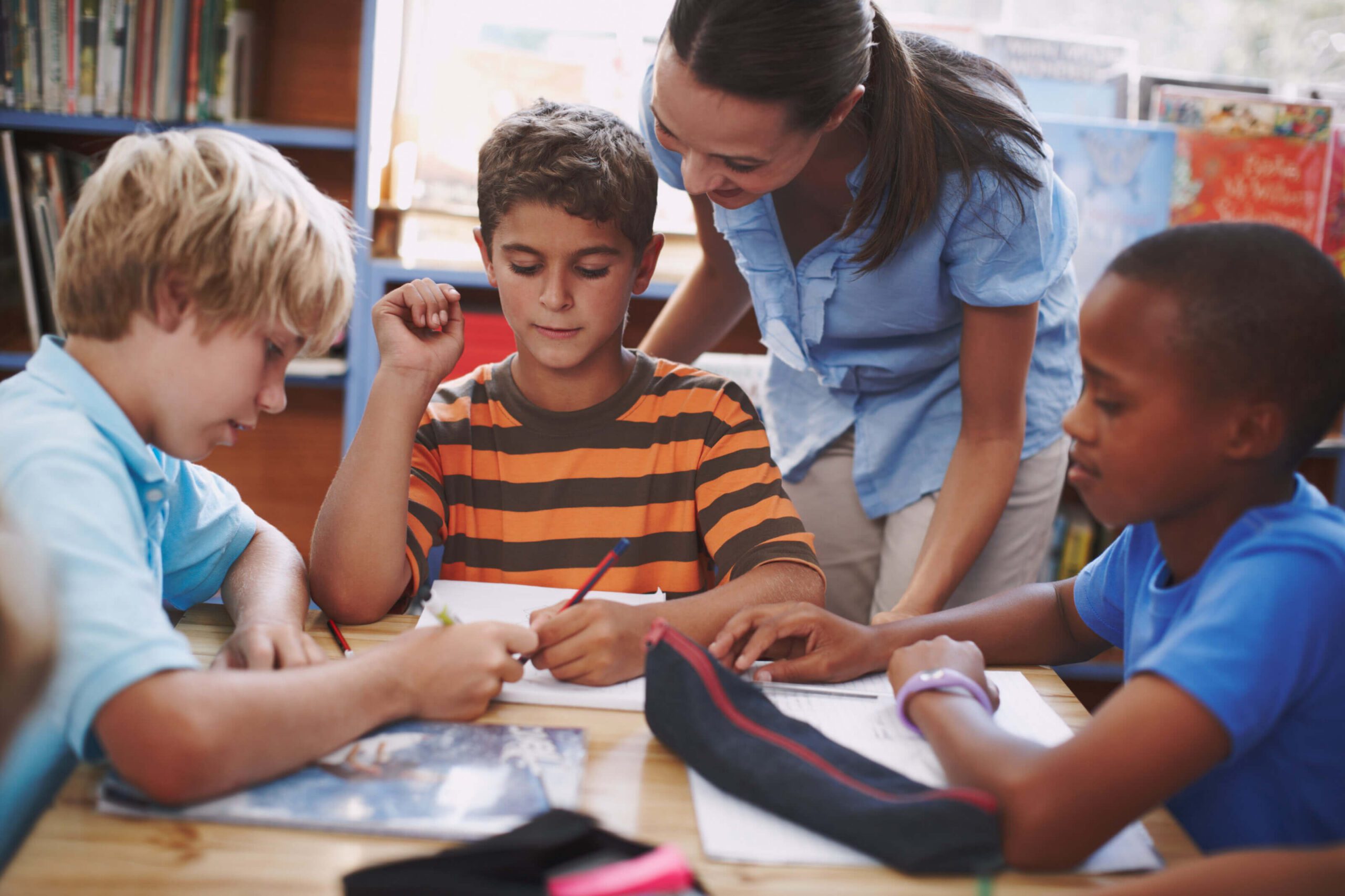 teacher tutoring student at school