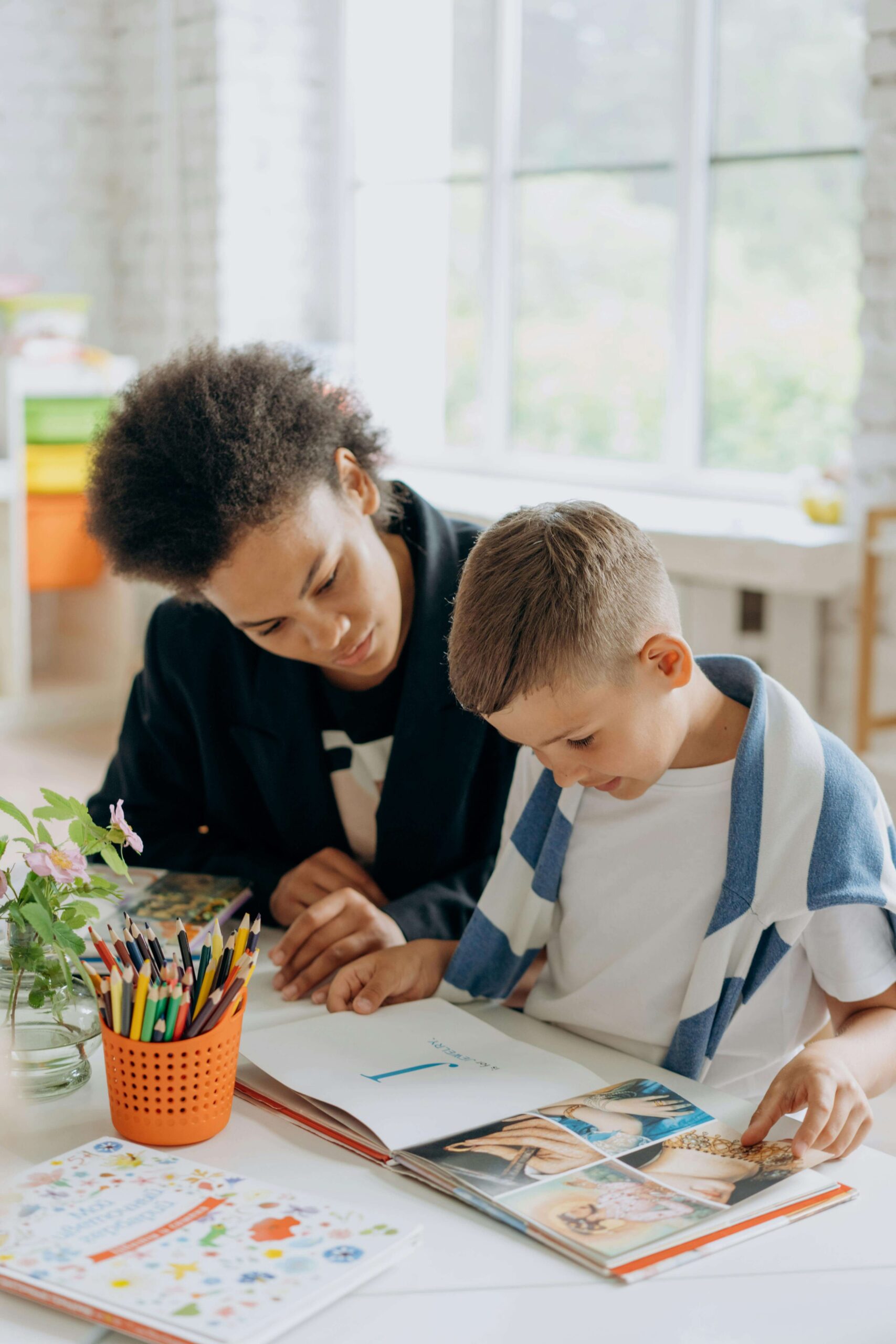 child working with a dyslexia tutor at a table